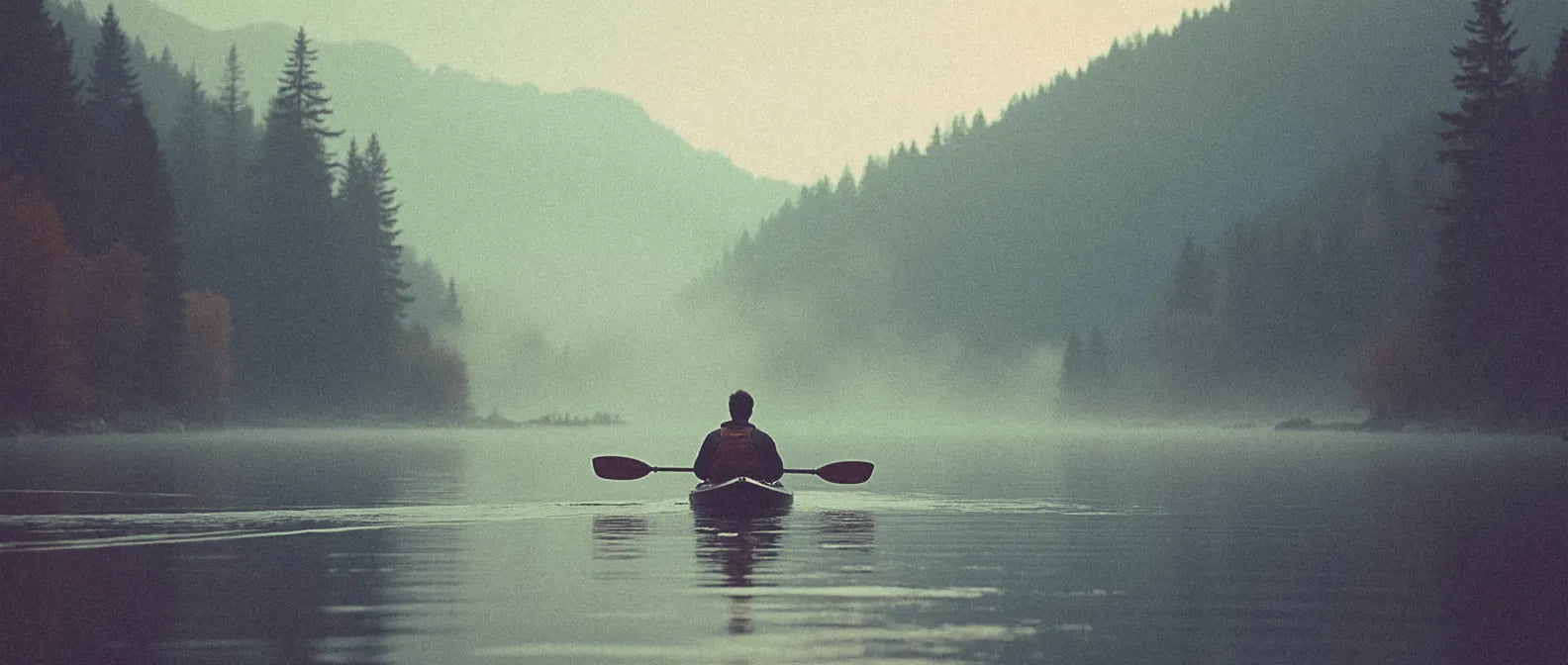 man kayaking on misty lake in the mountains - zoba fuel